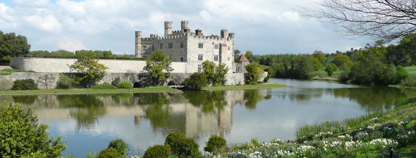 Photo of Leeds Castle in the background and the large mote surrounding it.